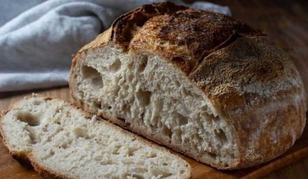 Premium Photo  Gluten free fresh bread in kitchen towel on light