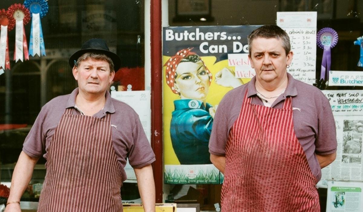 Butchers standing outside a butchers shop