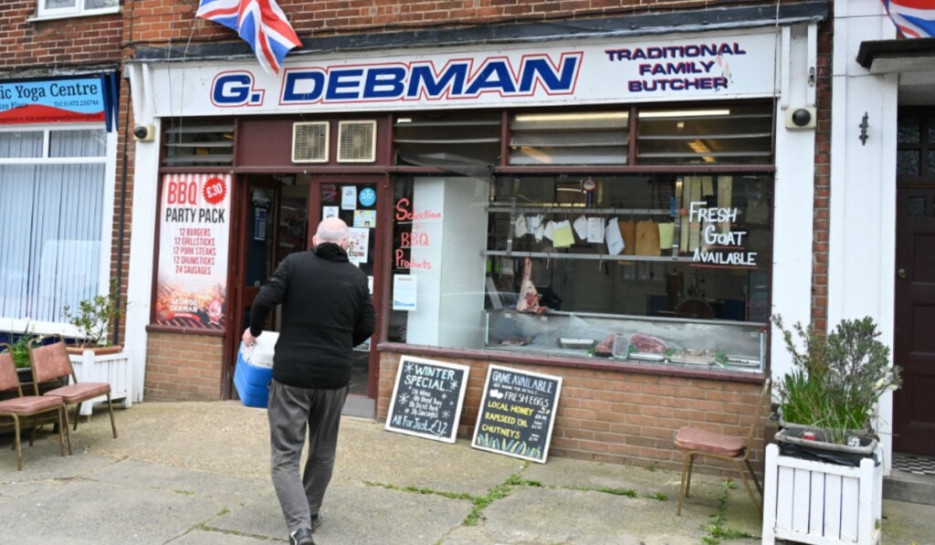 George Debman entering G. Debman butchers