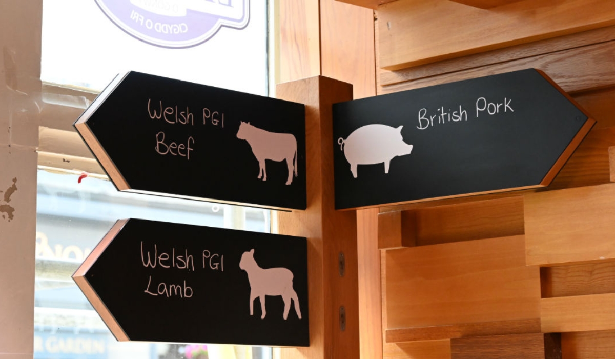 A sign post points in three directions to Welsh PGI Beef, Welsh PGI Lamb and British Pork