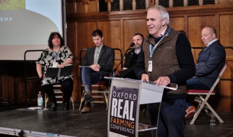SFT CEO, Patrick Holden, standing at a podium to introduce our Grazing Livestock session at the Oxford Real Farming Conference 2024