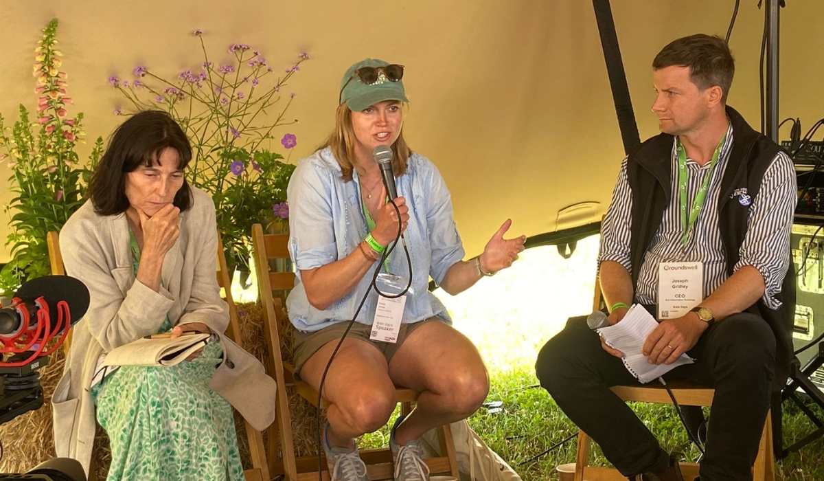 Fabia Bromovsky, GFM Director, Adele Jones, SFT Executive Director and Joseph Gridley, SAX CEO, sit together with Adele holding the mic as she speaks