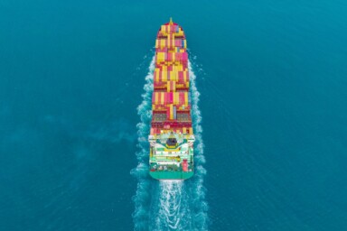 Birds eye view of a cargo ship sailing through the ocean. Image by Suphanat Khumsap via Getty Images.